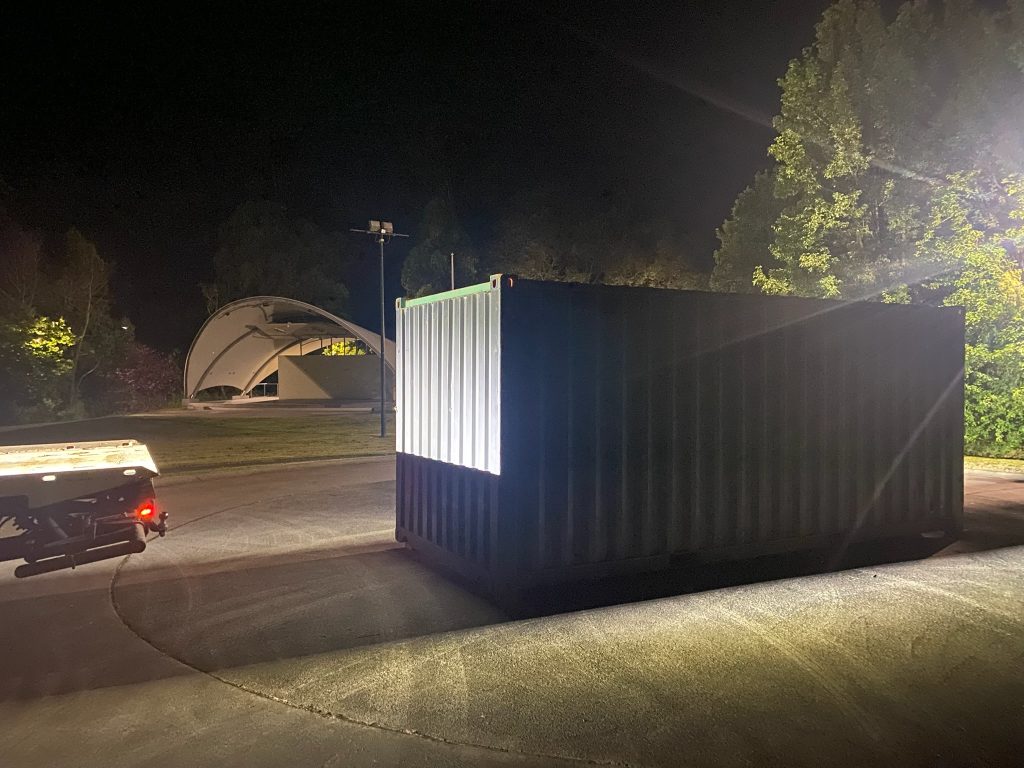 Shipping container delivered after dark on a concrete pad at Traralgon